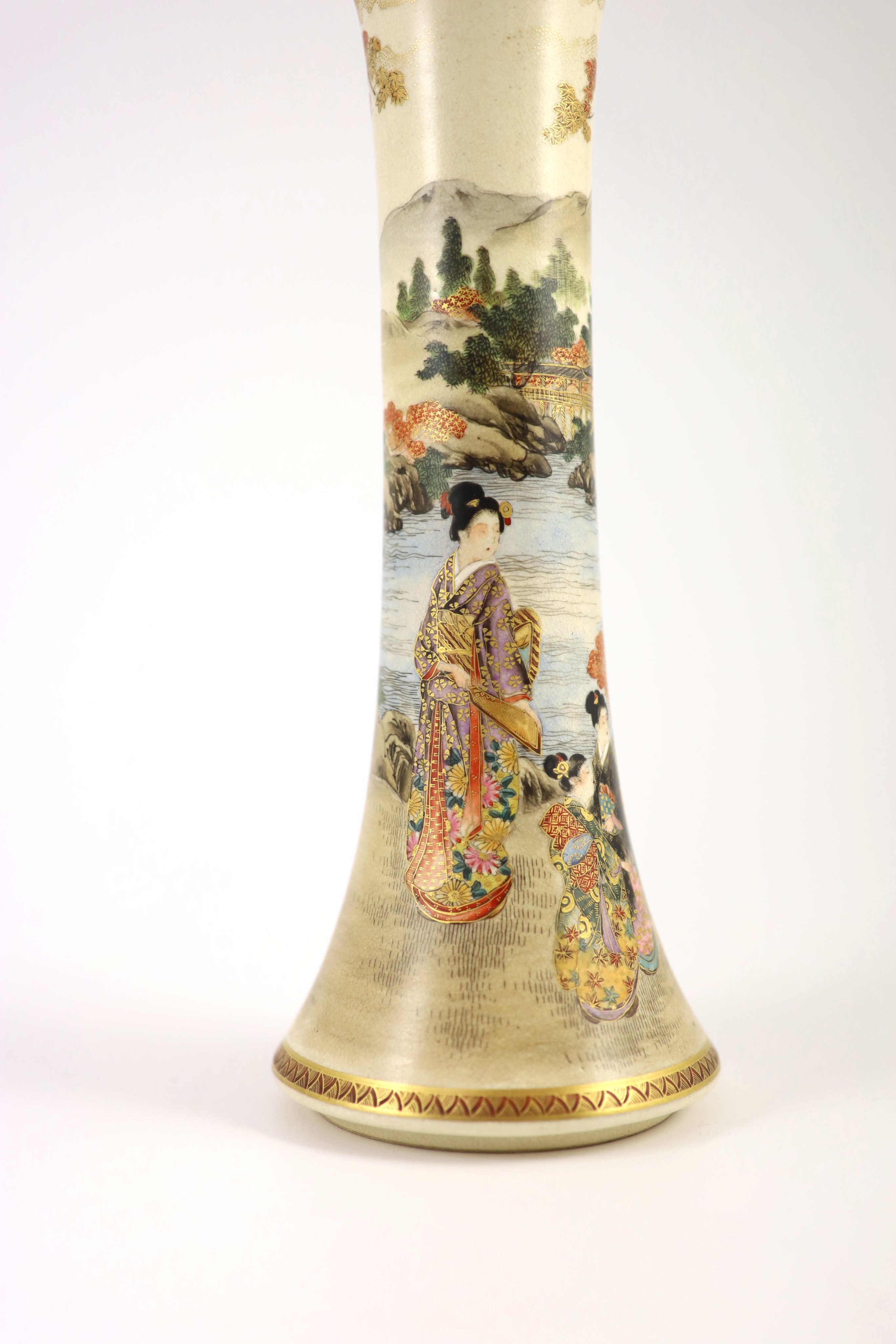 A Japanese satsuma earthenware trumpet vase by Kizan, Meiji period. The body painted and gilt with bijin and children in a lakeside landscape beneath a floral band rim, iron red and gilt signature to base. 30 cm high x 1